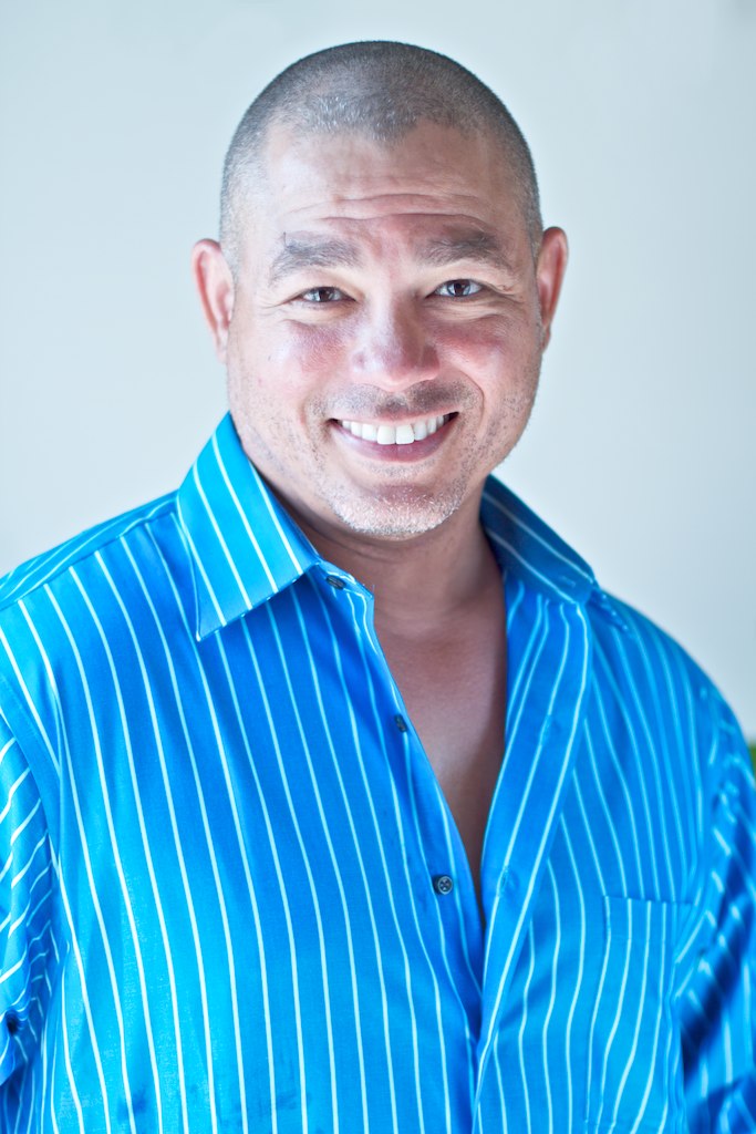 Devin Lockett, life coach and founder of California Brain Training, smiling in a blue shirt